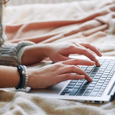 Unrecognizable woman type on laptop, close up view. Work at home, experienced freelance programming, writing code, remote job concept.