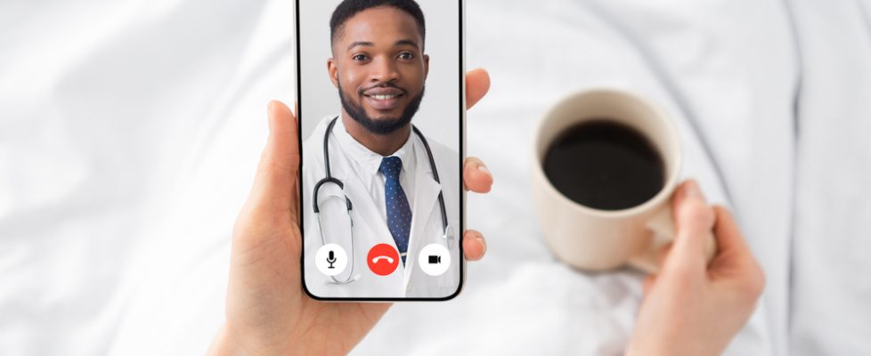 Woman,Having,Video,Call,With,Doctor,Lying,In,Bed,At Woman,Having,Video,Call,With,Doctor,Lying,In,Bed,At